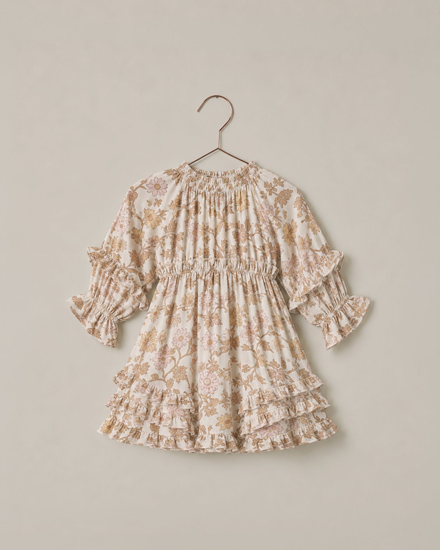 Noralee Harvest Bloom Mirabelle Dress displayed on a hanger with floral pattern and flowing fabric.
