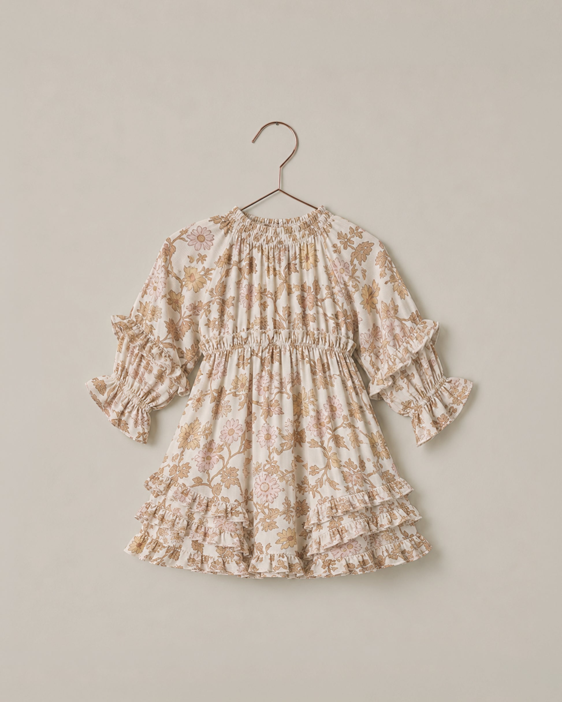 Noralee Harvest Bloom Mirabelle Dress displayed on a hanger with floral pattern and flowing fabric.