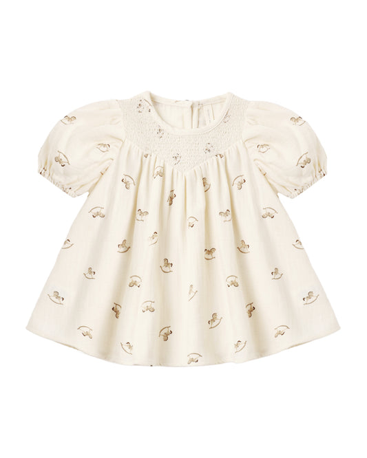 Quincy Mae Carina Dress for girls featuring a charming rocking horse pattern on soft, comfortable fabric.